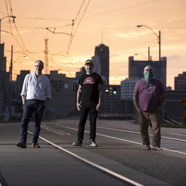 Lucero group photo with the city in the background.